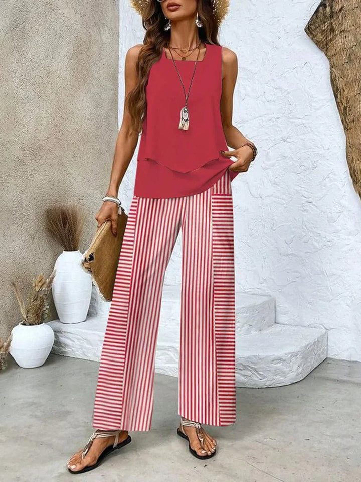 Sleeveless red top paired with printed pants for a coordinated outfit. Light and breezy material with a vibrant and trendy…