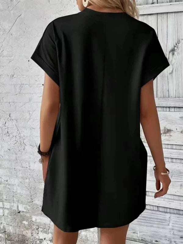 "Black mini dress made of soft cotton blend with convenient pockets, perfect for everyday wear or casual occasions."