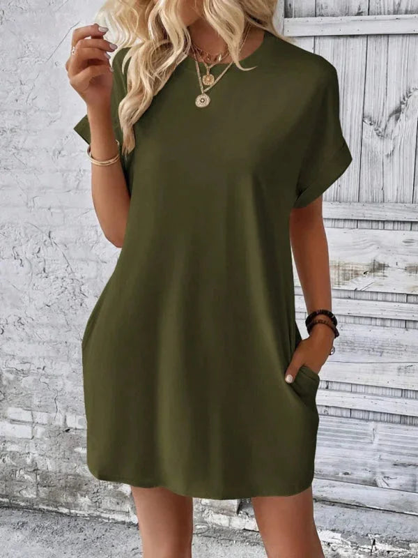 "Charcoal grey mini dress made with soft organic cotton, featuring practical pockets and relaxed fit for everyday wear."