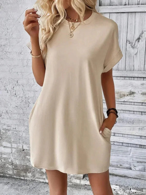 "Gray mini dress with pockets, made from soft cotton blend. Perfect for everyday wear with a cozy fit and practical design."