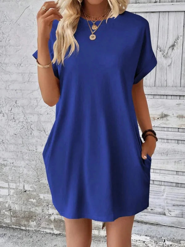"Blue mini dress with pockets made from soft cotton blend, featuring a relaxed fit and versatile design."