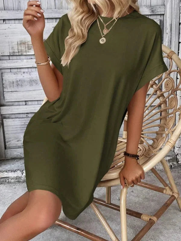 "Black mini dress with front pockets, made of breathable cotton fabric, perfect for all-day comfort and casual style."