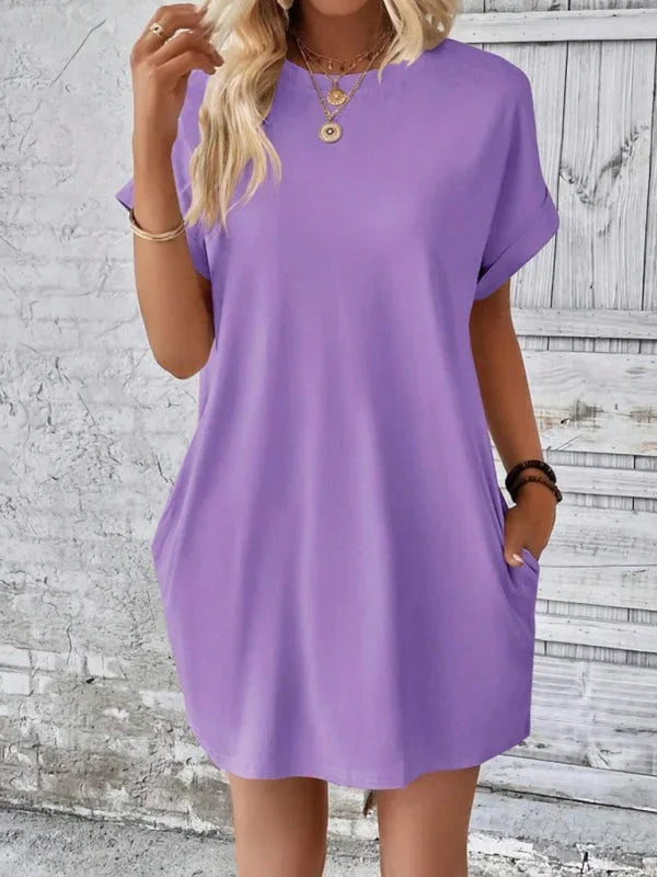 "Green linen mini dress with functional pockets, perfect for everyday wear."