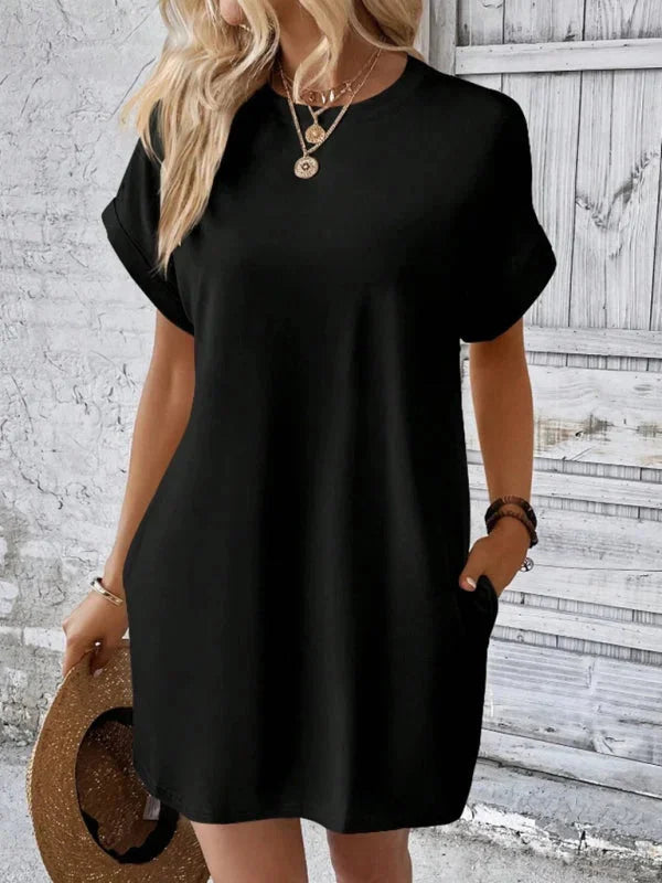 Black mini dress with convenient pockets, made from soft and stretchy fabric. Comfortable and versatile for everyday wear.