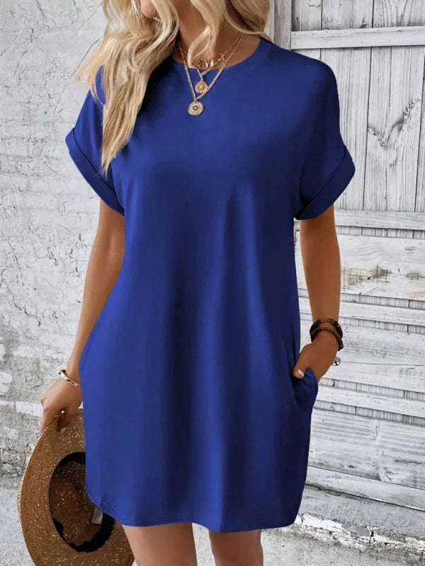 Blue mini dress made of soft and breathable fabric. Features practical pockets and a comfortable design.