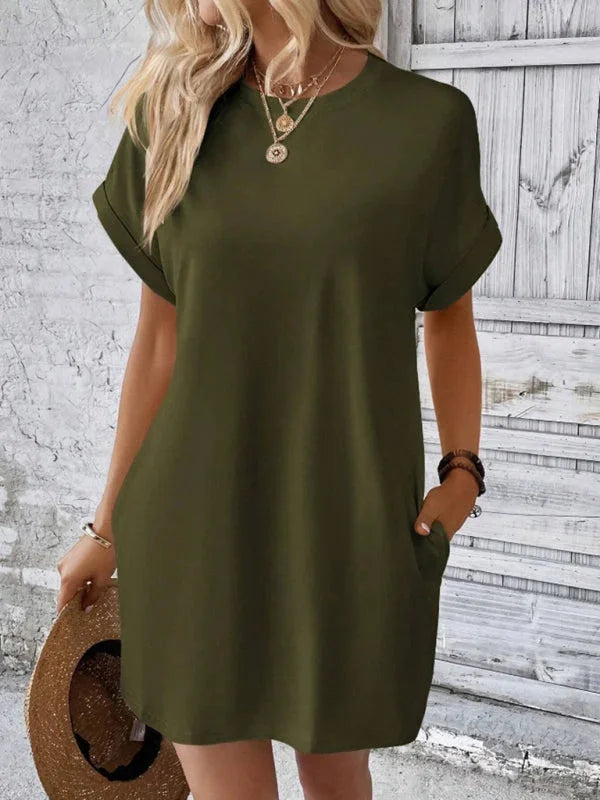 Green Ilani mini dress with convenient pockets, made from soft cotton blend. Knee-length design with a relaxed fit for…