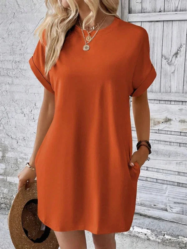 Orange mini dress with pockets, made of soft, breathable fabric. Versatile and comfortable design perfect for everyday wear.