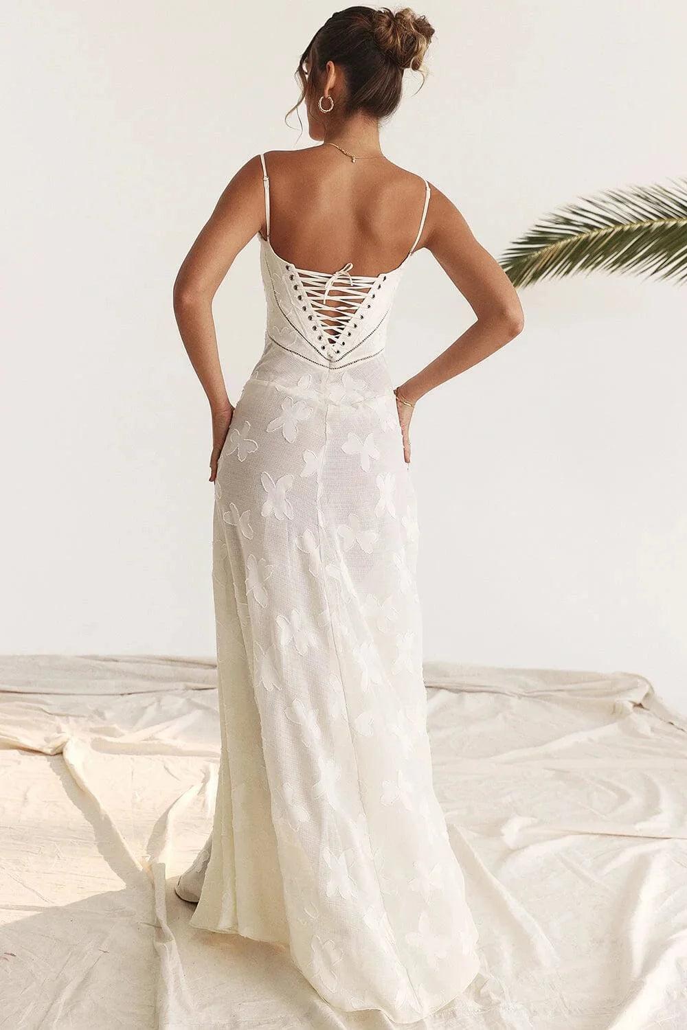 Black floral lace maxi dress with spaghetti straps, perfect for a boho chic look.