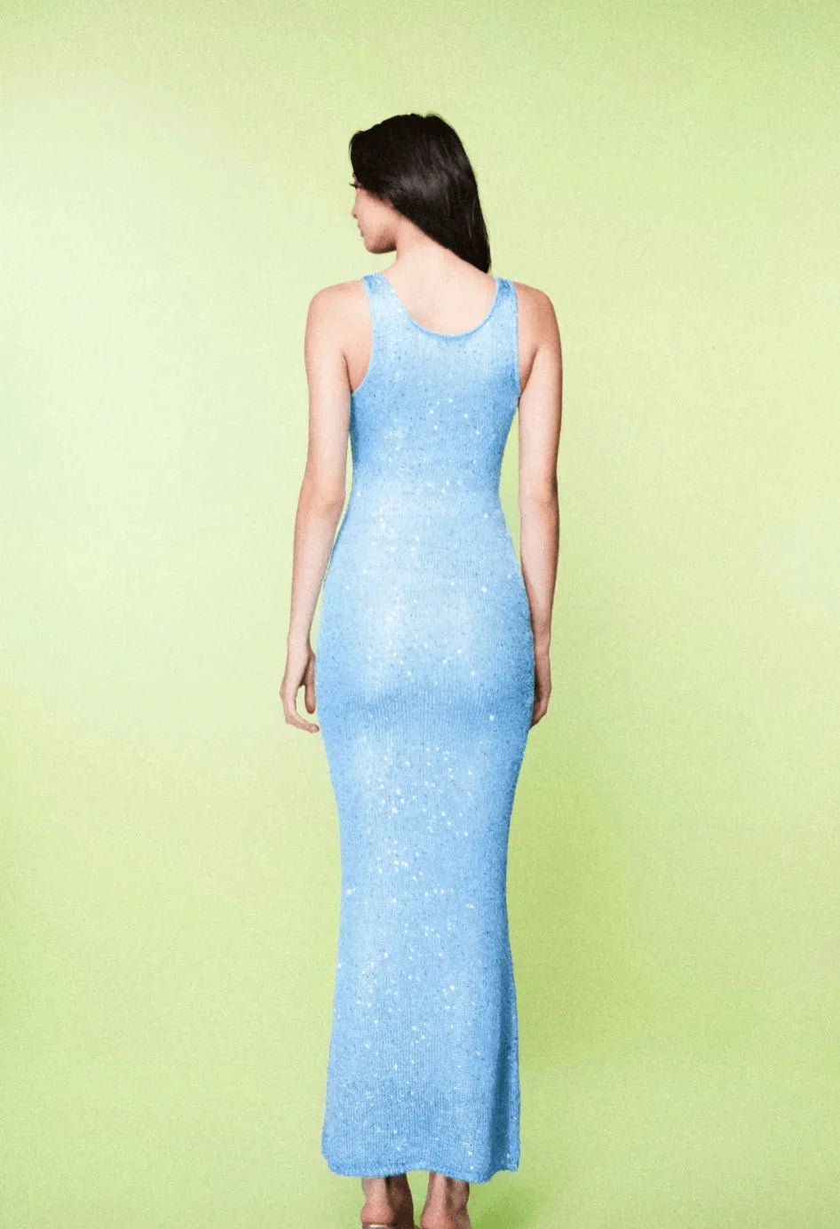 "Sleeveless fitted maxi dress in icy blue with draped neckline and floor-length silhouette, perfect for summer weddings and…