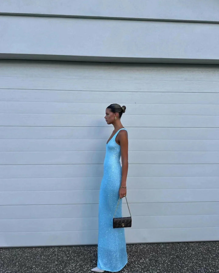 Sleeveless maxi dress in icy blue, form-fitting design, perfect for summertime.