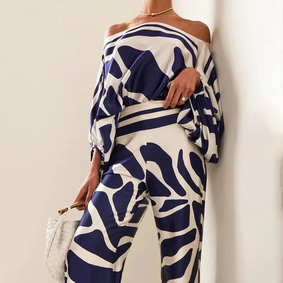 Off-shoulder blouse and straight pants set, made with soft cotton blend fabric, featuring a stylish and modern design in a…