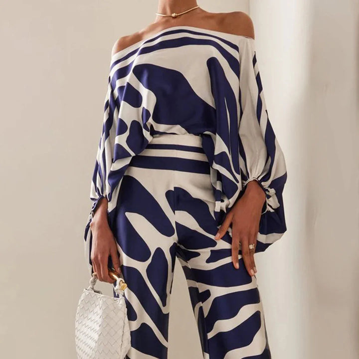 Off-shoulder blouse and straight pants set in soft cotton blend, perfect for a casual-chic look on a sunny day.