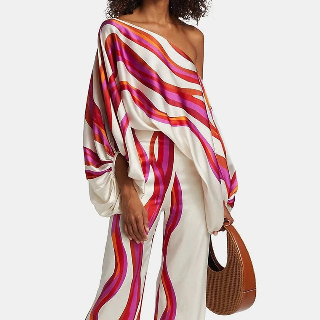 Off-shoulder blouse and straight pants set in a soft, flowy fabric. Stylish design with trendy off-shoulder detail. Classic…