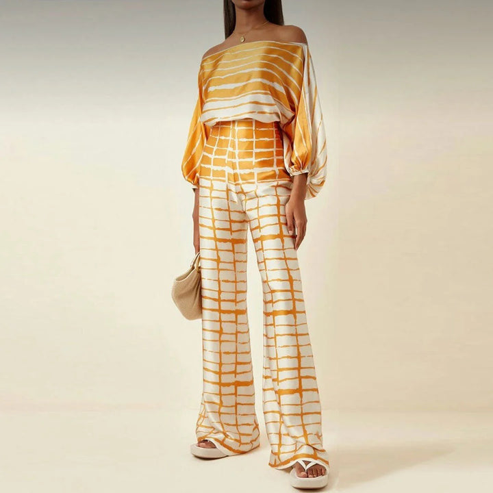 Yellow off-shoulder blouse and straight pants set featuring a lightweight, breathable fabric with a chic, trendy design for…
