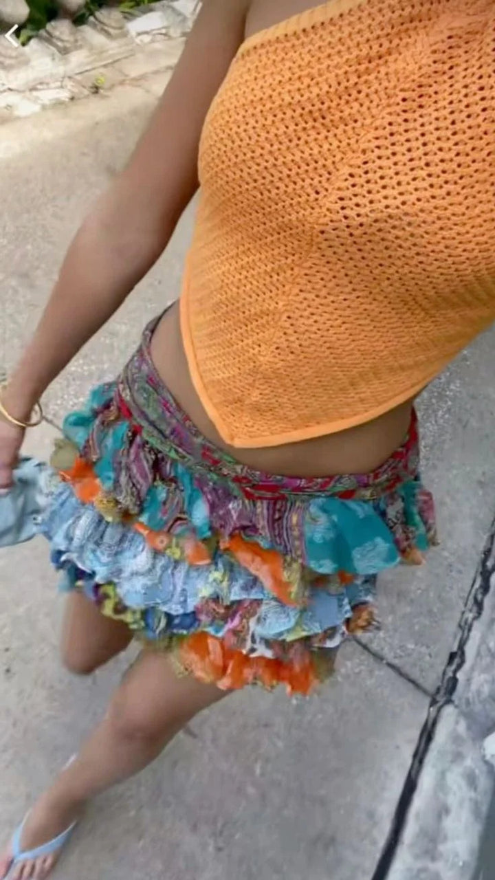 "Vibrant multicolor ruffle mini skirt with lively design, made of lightweight and breathable fabric for a stylish look."