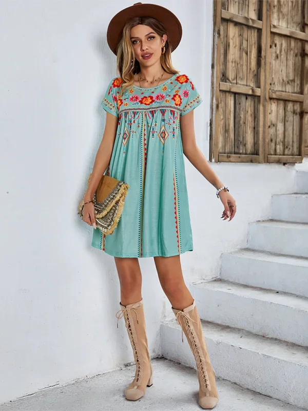 Alt text: "Jaclyn - Embroidered boho mini dress in lightweight cotton with intricate stitching and tassel ties, perfect for…