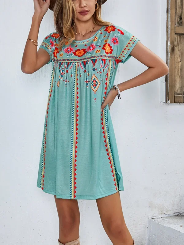 Green boho mini dress with beautifully embroidered detailing, ideal for a casual day out in the sun.