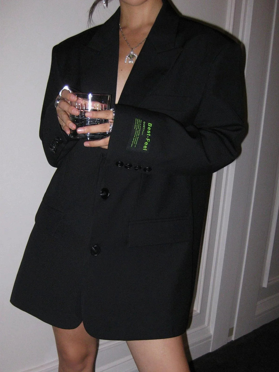 Black oversized blazer with sleek buttons and pockets, tailored from a soft wool blend fabric for a comfortable and stylish…