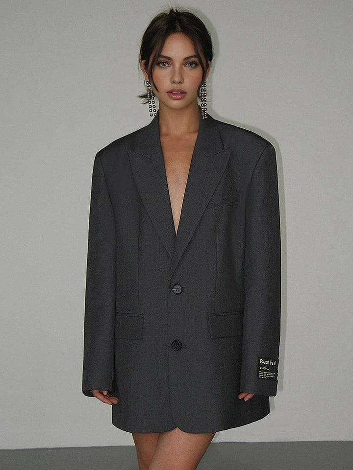 Oversized black blazer with sleek buttons and pockets, made of premium wool blend for a polished, sophisticated look.