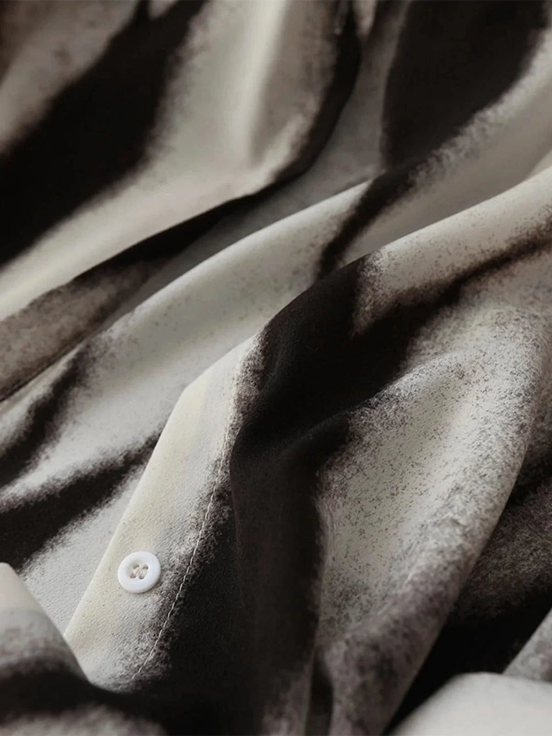 "Abstract print button-up blouse in soft chiffon fabric, with a stylish and modern design by Jada."