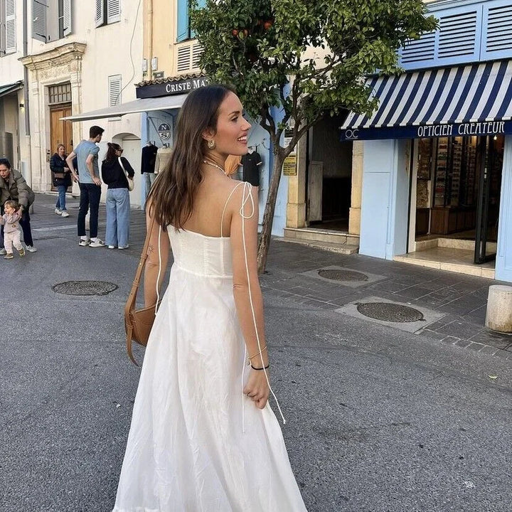 White maxi dress with ruched bodice, made from soft and flowy fabric. Features a flattering silhouette perfect for any…