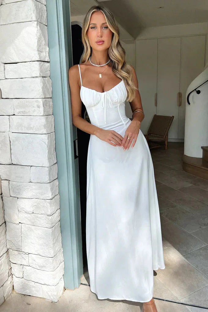 Flowy white maxi dress with adjustable straps, perfect for warm weather days. Soft and lightweight fabric for effortless…