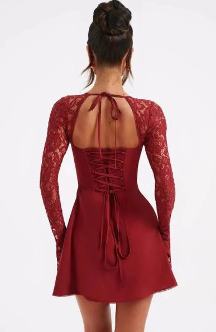 Feminine and elegant lace detailed mini dress with bow accentuates waist, perfect for special occasions or date nights.