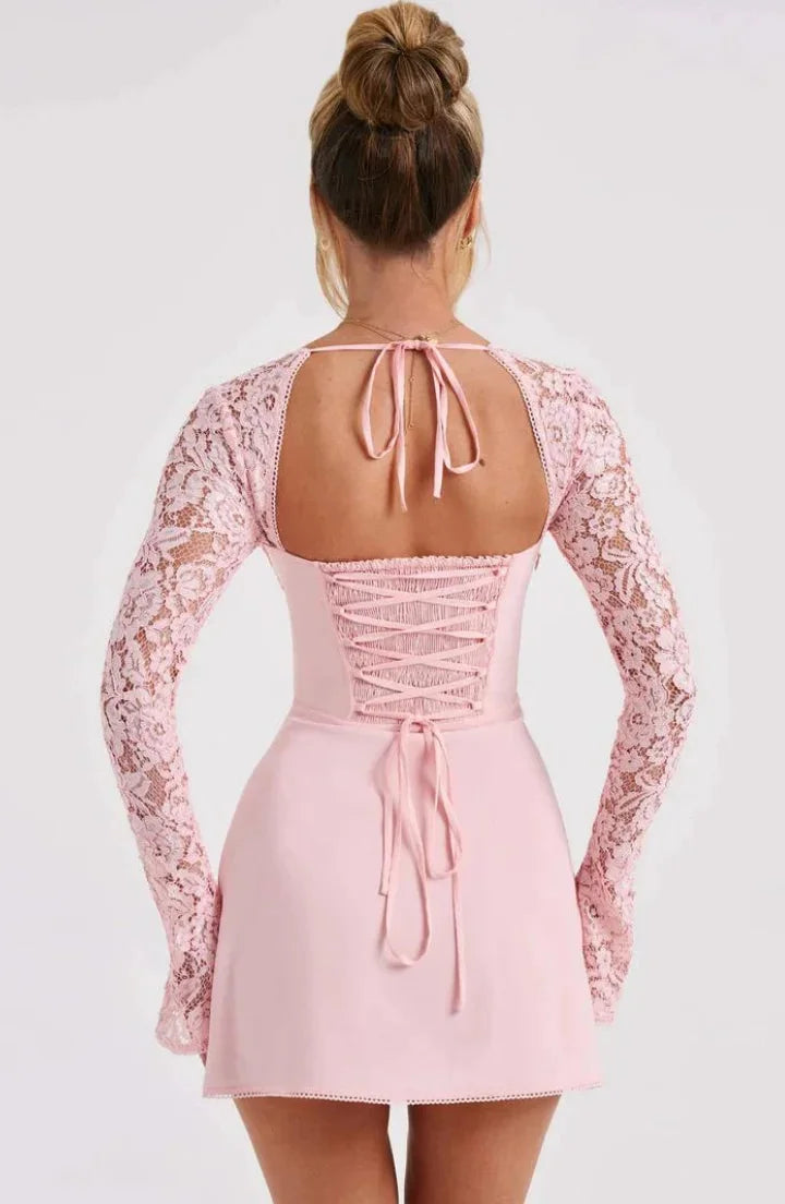 "Black mini dress with lace detailing and bow accent, perfect for a chic and sophisticated look."