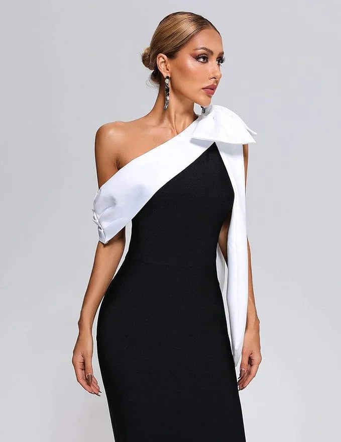 "Black and white midi dress featuring asymmetrical design, suitable for casual or formal events. Made from comfortable and…