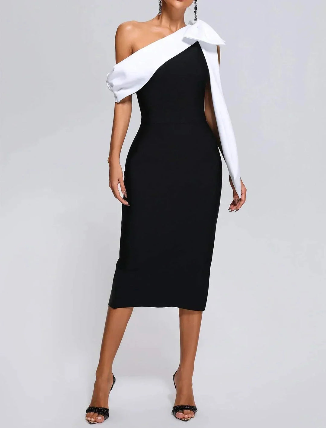 Black and white midi dress showing asymmetrical design, made with a blend of materials, perfect for a modern and stylish…
