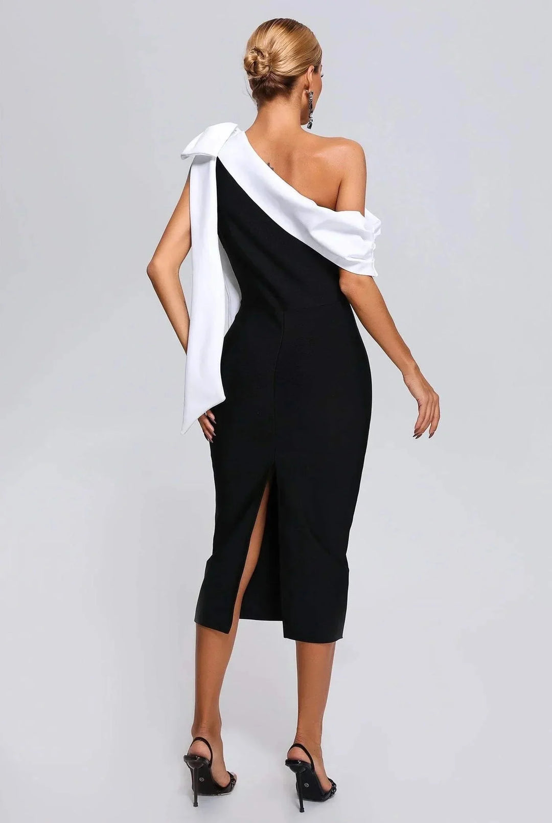 Black and white midi dress with asymmetrical design, made from high-quality fabric, stylish for casual or formal occasions.