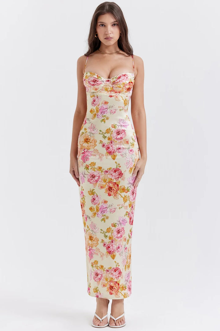 Floral print fitted maxi dress with yellow base featuring a lightweight and flowy fabric perfect for a breezy summer day.