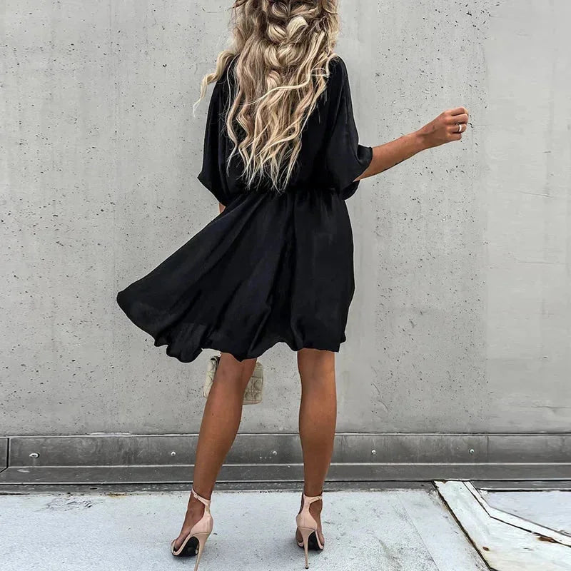 "Jasmine flowy V-neck mini dress in soft, lightweight fabric with elegant design for casual or formal occasions."