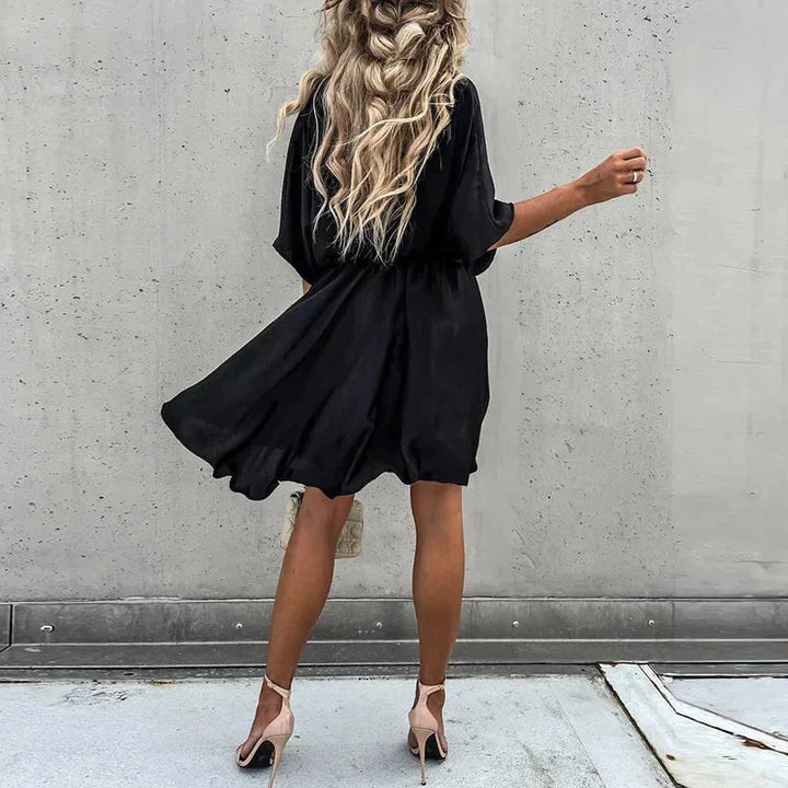"Jasmine flowy V-neck mini dress in soft, lightweight fabric with elegant design for casual or formal occasions."