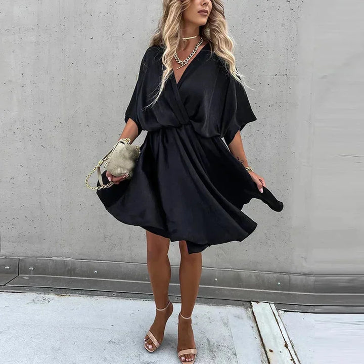 Flowy V-neck mini dress in Jasmine color, with a lightweight fabric and elegant silhouette perfect for casual or formal…