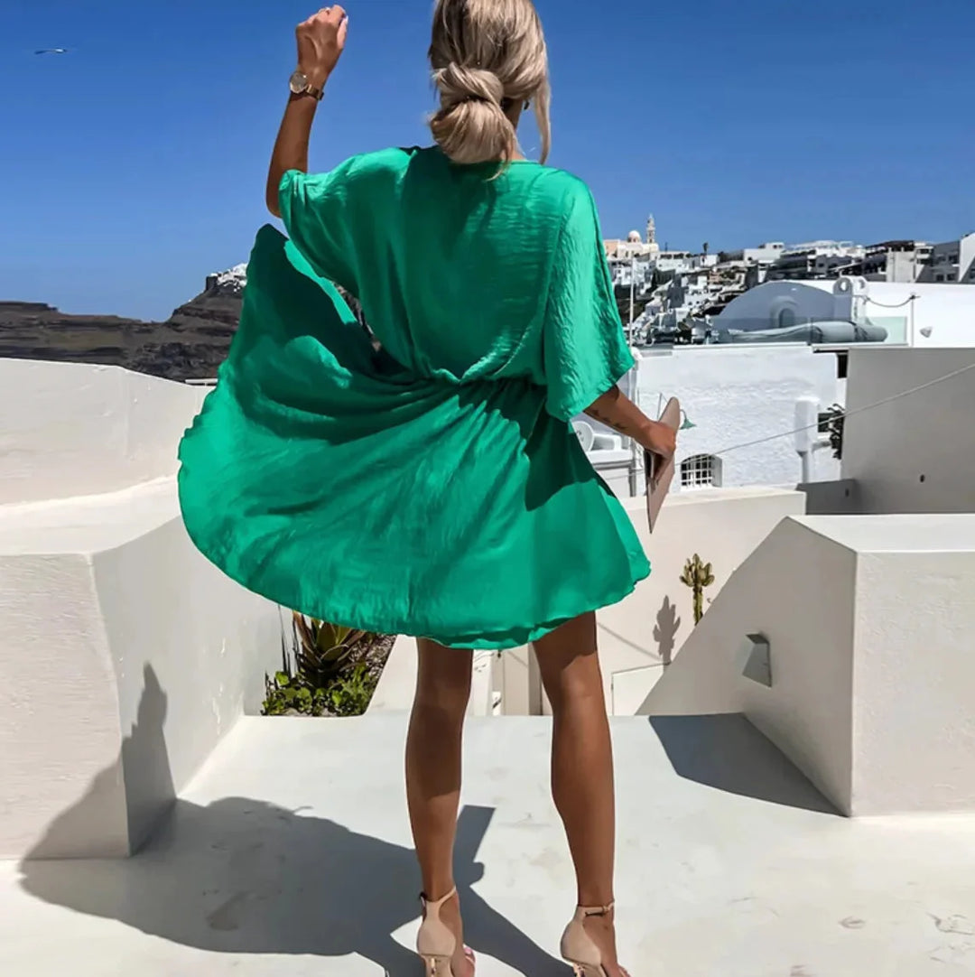 "Jasmine flowy mini dress in a soft, breathable fabric with a flattering V-neck design for a casual yet chic look."