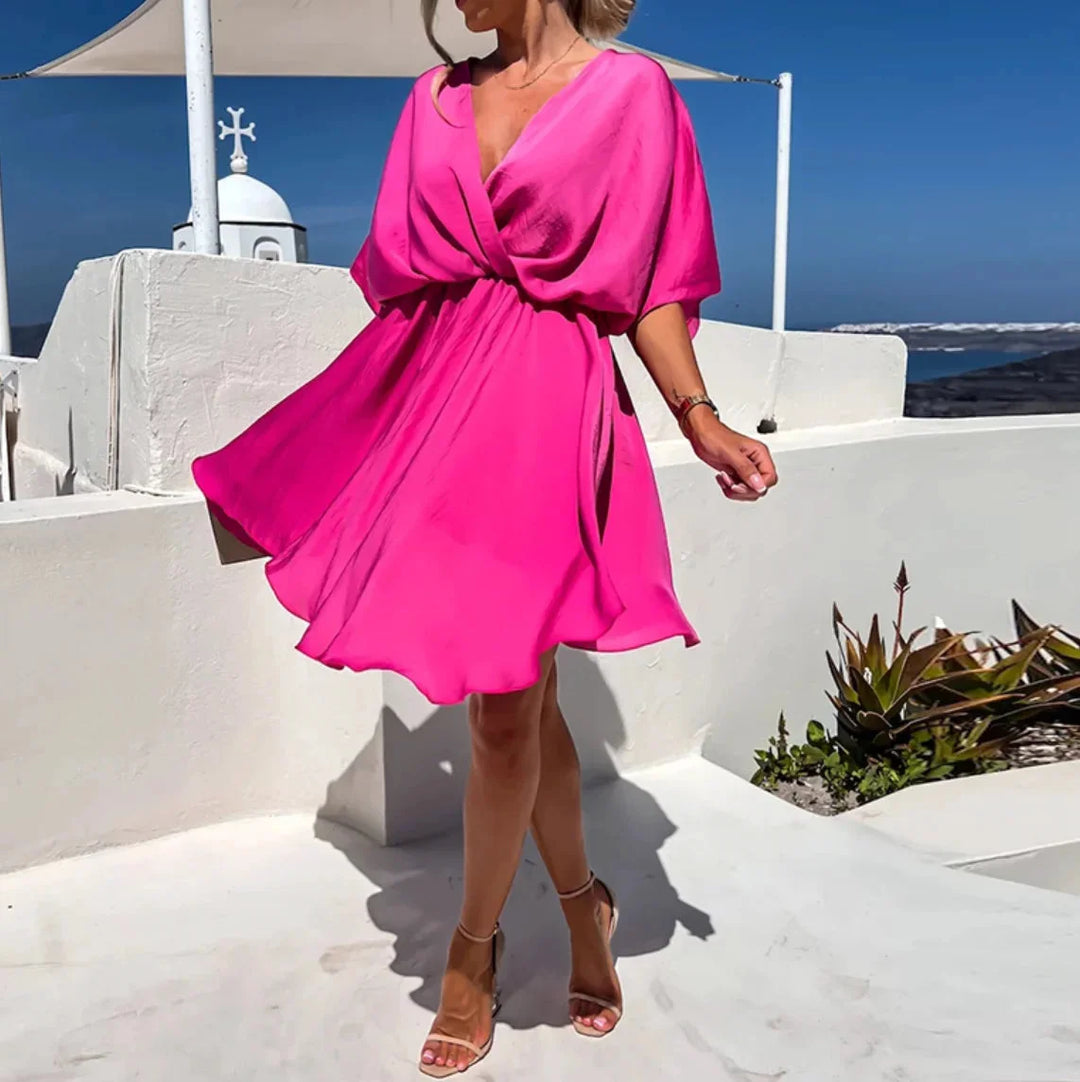 "Flowy v-neck mini dress in jasmine color with a relaxed fit and breezy silhouette, perfect for a casual day out."