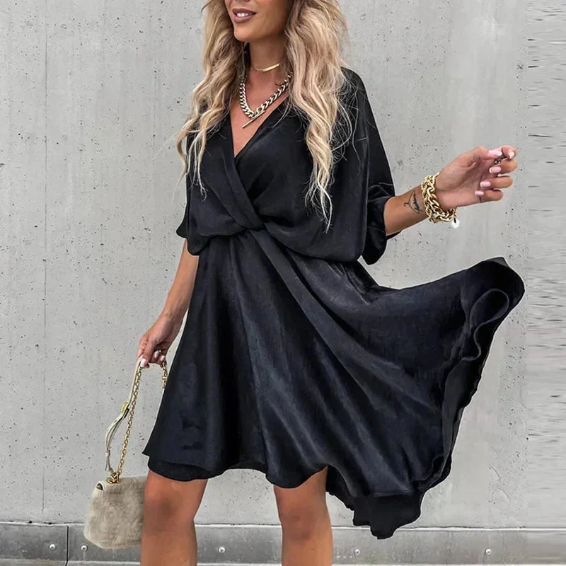 Black flowy V-neck mini dress made of lightweight fabric. Features delicate jasmine print on a relaxed silhouette.