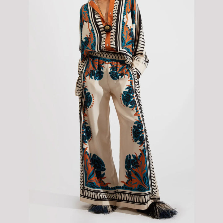 "Orange Jasper bohemian set featuring lightweight fabric, floral patterns and tassel details for a trendy spring look."