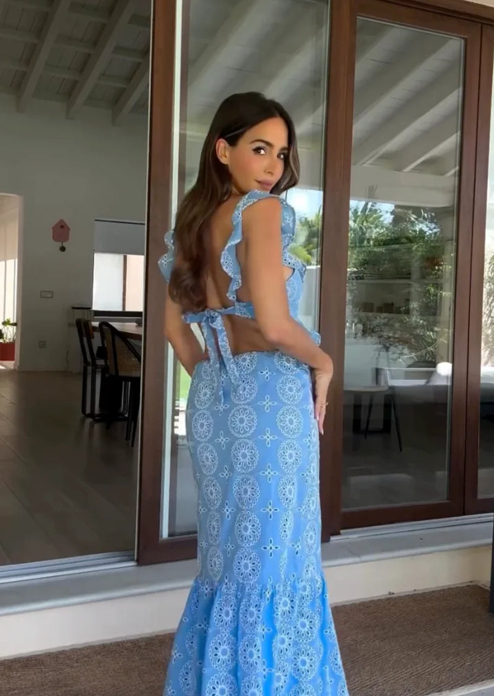 Blue patterned maxi dress with ruffles in a textured fabric. Flowy and elegant design perfect for a summer day out.