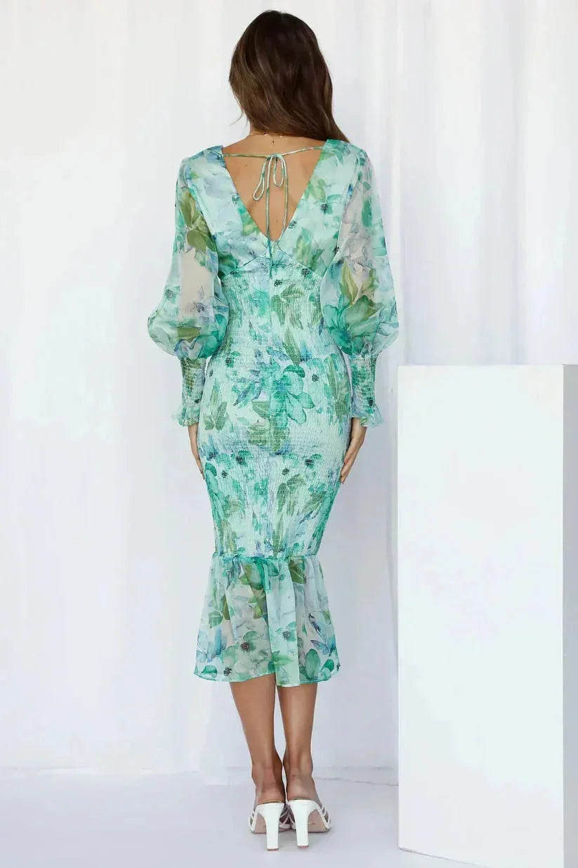 Women's ruched midi dress with flare hem in soft, flowy fabric. Features flattering ruching detail and elegant midi length.