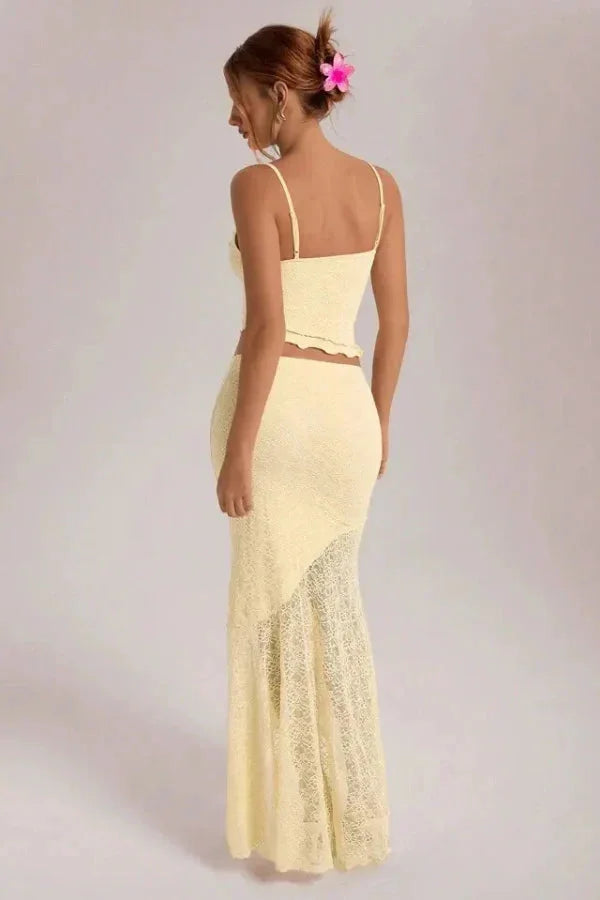 Cream lace crop top and skirt set for women. Features delicate lace detailing on a feminine design in a creamy color palette.