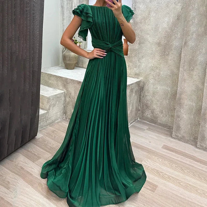 Green pleated maxi dress with ruffled sleeves, made from flowy polyester fabric. Perfect for a stylish and elegant look.