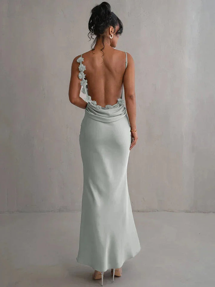 Light green sleeveless maxi dress with floral accents, made of soft and flowy fabric. Ideal for occasions or casual wear.