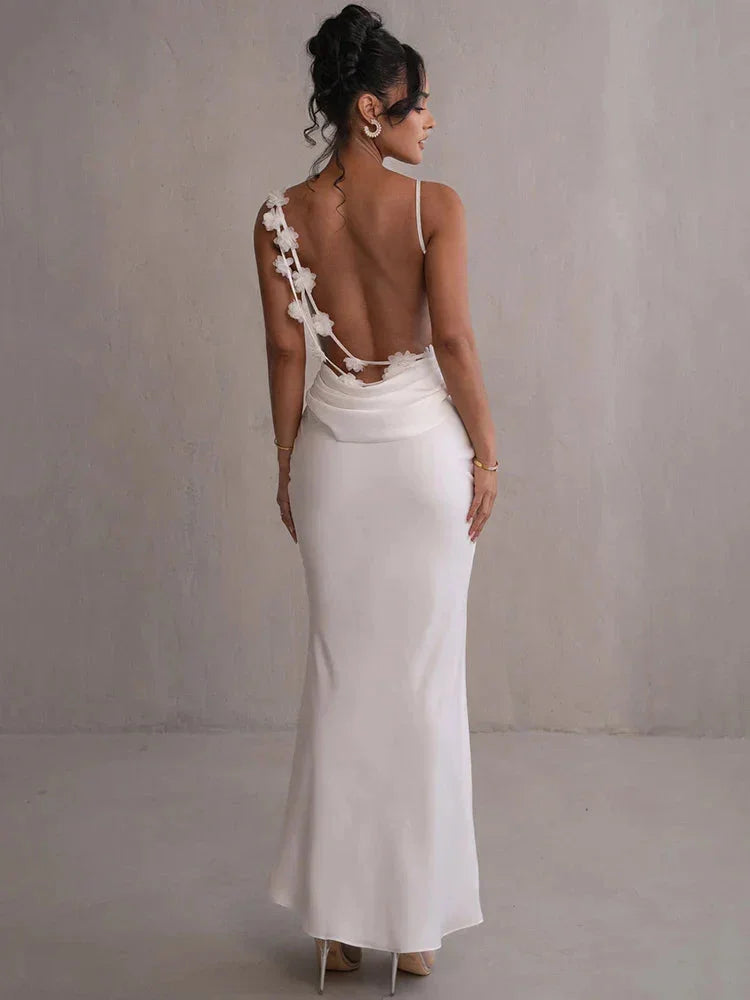 White sleeveless maxi dress with floral accents, perfect for summer. Made with lightweight and breathable fabric, featuring…