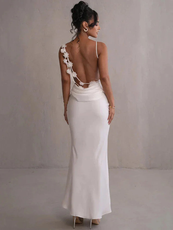 White sleeveless maxi dress with floral accents, perfect for summer. Made with lightweight and breathable fabric, featuring…