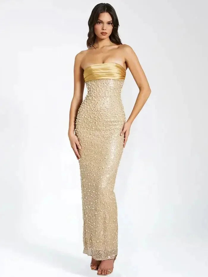 "Women's gold strapless maxi dress with elegant design and flowy fabric for a stylish look at special occasions."