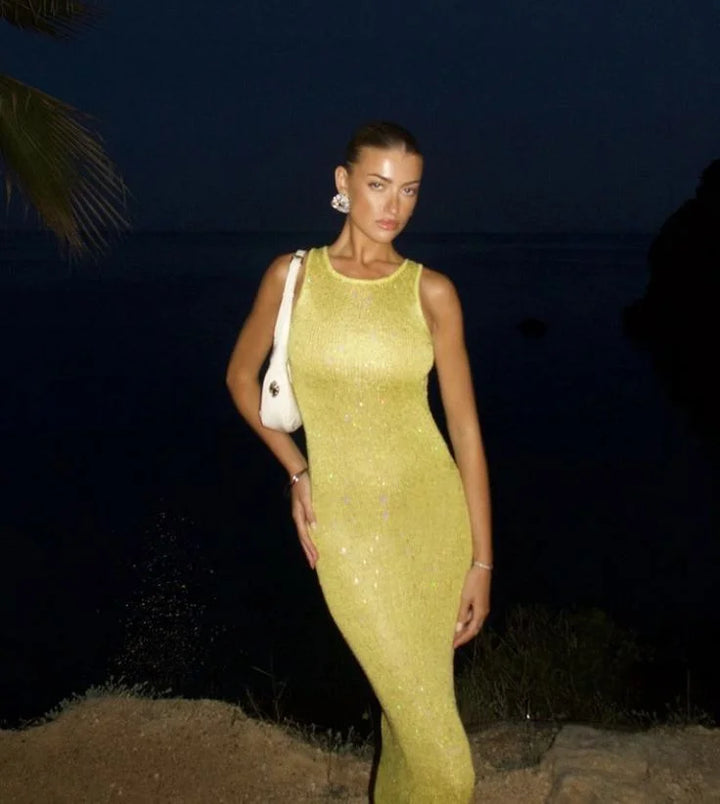Sleeveless sparkling maxi dress in silver with sequin embellishments, perfect for evening gatherings.
