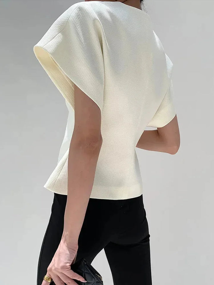 Chic wrap-style blouse in soft cotton with sculpted sleeves, perfect for adding polish to any outfit.