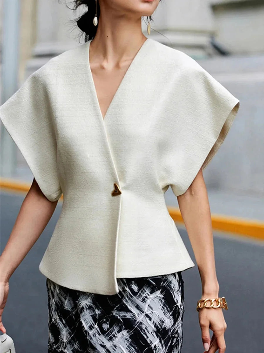 Chic wrap-style blouse in soft crepe fabric with sculpted sleeves in solid color.
